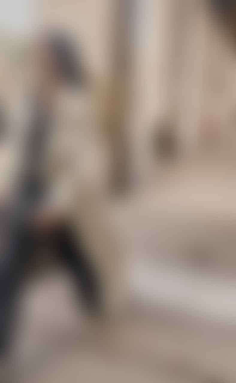 Stylish Parisian woman in chic French fashion walking on Paris streets